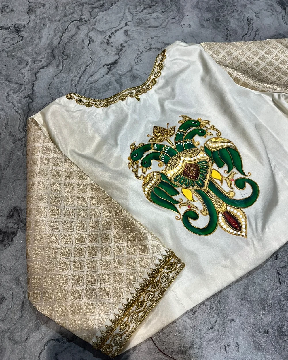 Ivory blouse with a hand-painted green and gold bird motif
